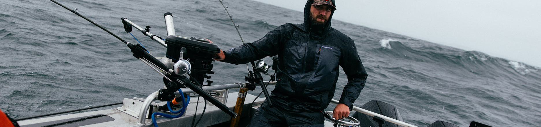 Angler wearing Grundens Jacket while fishing.