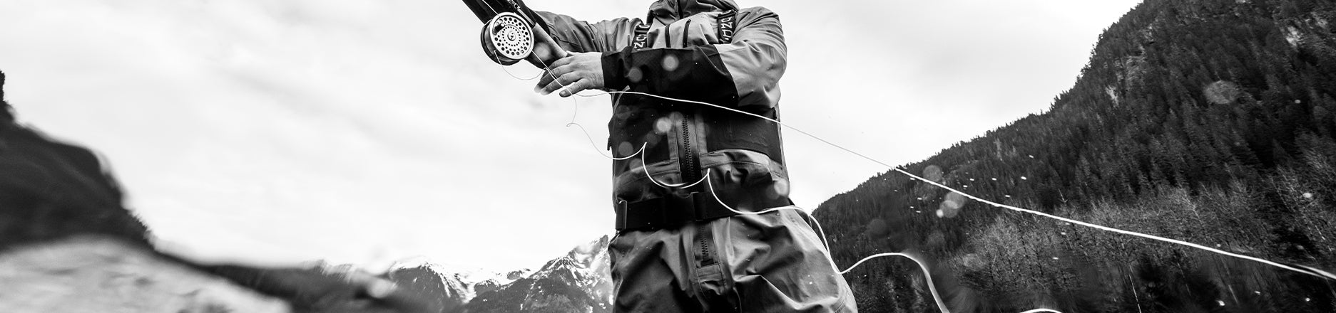 Grundens waders, angler casting and wading in river