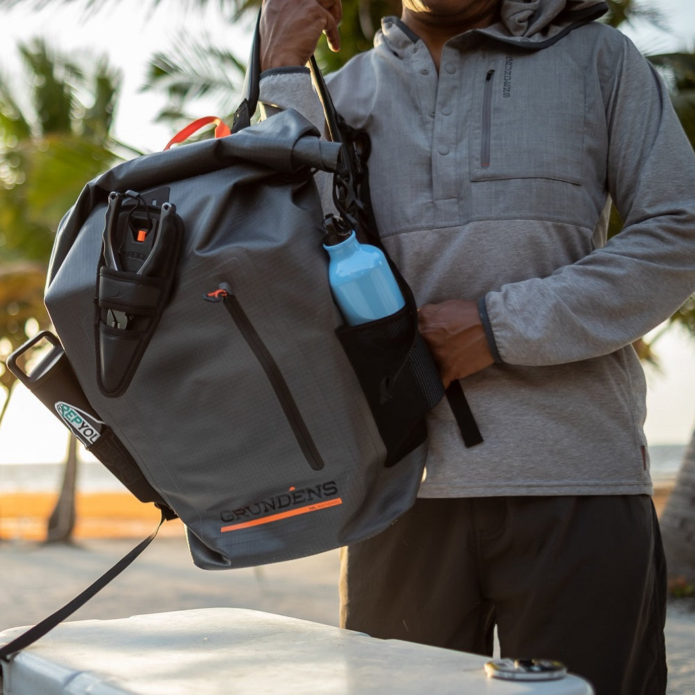 Exterior mesh bottle pockets with rod tube lash system