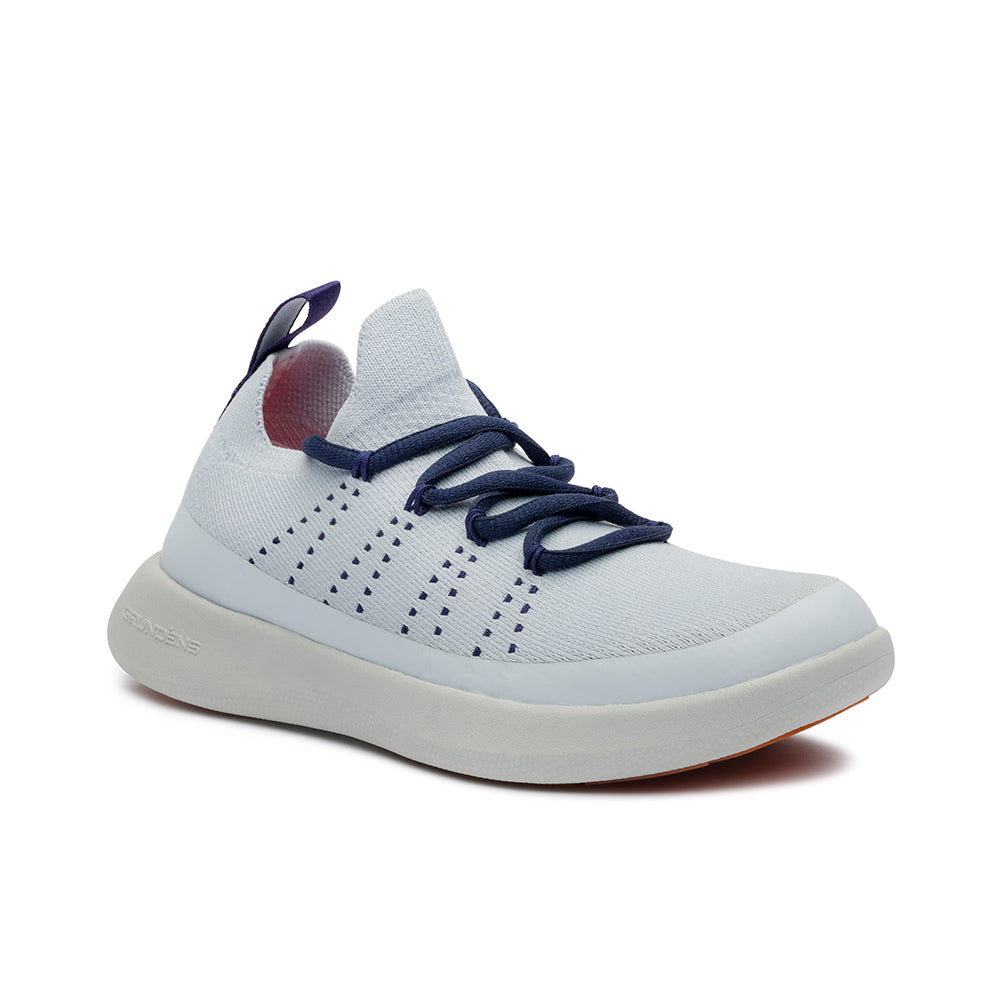 Light blue boat shoe with navy laces and a textured upper, featuring a cushioned sole and pull tab at the heel.